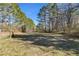 Open field with a gate leading into the woods at 446 Mcgukin Rd, Bremen, GA 30110