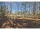 Wooded area with mature trees and leaf-covered ground at 446 Mcgukin Rd, Bremen, GA 30110