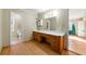 Bathroom with vanity, mirror, and access to another bathroom at 12205 Highway 36, Covington, GA 30014
