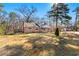 Brick ranch house with a large yard and mature trees at 12205 Highway 36, Covington, GA 30014