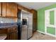 Kitchen features stainless steel refrigerator and wood cabinets at 12205 Highway 36, Covington, GA 30014