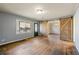 Living room with hardwood floors and barn doors leading to dining area at 12205 Highway 36, Covington, GA 30014