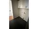 Laundry room with white cabinets and dark tile flooring at 1902 E Piedmont Rd, Marietta, GA 30062