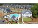 Aerial view of community pool and clubhouse, with neighborhood homes and lush landscaping at 204 Dawson Dr, Woodstock, GA 30188