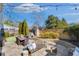 Backyard with a stone patio featuring outdoor seating, grill, and string lights for evening ambiance at 204 Dawson Dr, Woodstock, GA 30188