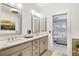 Bathroom with double sinks, granite counters, and a view to the bedroom at 204 Dawson Dr, Woodstock, GA 30188