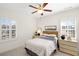 Bedroom featuring white walls, shutters, ceiling fan, and a well appointed, comfortable bed at 204 Dawson Dr, Woodstock, GA 30188