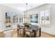 Charming dining room featuring modern chandelier, shuttered windows, and access to outdoor patio at 204 Dawson Dr, Woodstock, GA 30188