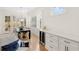 Elegant dining room with hardwood floors, wine storage, and natural light from shuttered windows at 204 Dawson Dr, Woodstock, GA 30188