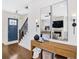 Welcoming entryway with hardwood floors, a staircase, and a view into the living room with a fireplace at 204 Dawson Dr, Woodstock, GA 30188