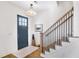 Elegant foyer featuring hardwood floors, staircase with iron railings, and a stylish front door at 204 Dawson Dr, Woodstock, GA 30188