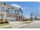 Beautiful two-story townhome featuring a brick front, an attached two-car garage, and manicured landscaping at 204 Dawson Dr, Woodstock, GA 30188