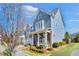 Attractive townhome with blue siding, brick accents, and professional landscaping, creating curb appeal at 204 Dawson Dr, Woodstock, GA 30188