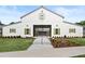 Elegant white barn-style building with green shutters, set on a beautifully landscaped lawn at 204 Dawson Dr, Woodstock, GA 30188