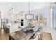 Open concept kitchen and dining area featuring white cabinets, stainless appliances, and large center island at 204 Dawson Dr, Woodstock, GA 30188