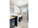 Neat laundry room with modern appliances, stylish wallpaper, butcher block counters, and ample storage at 204 Dawson Dr, Woodstock, GA 30188