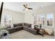 Spacious living room with a large sectional sofa, plantation shutters, and natural lighting at 204 Dawson Dr, Woodstock, GA 30188