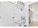 Bright mudroom with a bench, storage, hooks, and view into the ensuite bathroom at 204 Dawson Dr, Woodstock, GA 30188