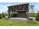 Open-air pavilion with exposed wood beams, flanked by manicured greenery at 204 Dawson Dr, Woodstock, GA 30188