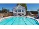 Large community pool with lounge chairs and umbrellas, and spacious pool deck at 204 Dawson Dr, Woodstock, GA 30188