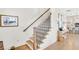 Staircase with wood treads and black iron railing; view to kitchen and dining at 204 Dawson Dr, Woodstock, GA 30188