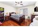 Bedroom with hardwood floors, ceiling fan, and double bed at 24 Planters Sw Dr, Lilburn, GA 30047