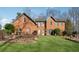 Brick house with landscaped lawn at 24 Planters Sw Dr, Lilburn, GA 30047