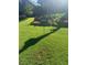 Lush green lawn with award-winning landscaping at 24 Planters Sw Dr, Lilburn, GA 30047