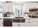 Modern kitchen with farmhouse sink and granite countertops at 24 Planters Sw Dr, Lilburn, GA 30047