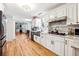 Modern kitchen with white cabinets and granite countertops at 24 Planters Sw Dr, Lilburn, GA 30047