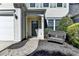 Welcoming front door with pathway and bench seating enhance curb appeal at 221 Kenninghall Se Ln, Smyrna, GA 30082