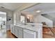 Open kitchen view into living room boasts marble countertop and stainless steel appliances at 221 Kenninghall Se Ln, Smyrna, GA 30082