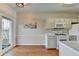 Bright kitchen with wood floors, white cabinets, marble countertops, and stainless steel appliances at 221 Kenninghall Se Ln, Smyrna, GA 30082