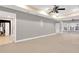 Finished basement featuring gray walls and ceiling fan at 2265 Wildwood Lake Dr, Suwanee, GA 30024