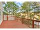 Deck overlooking a tranquil lake with wooded backdrop at 2265 Wildwood Lake Dr, Suwanee, GA 30024