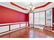 Spacious dining room with hardwood floors, red walls, and chandelier at 2265 Wildwood Lake Dr, Suwanee, GA 30024