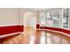 Formal dining room with hardwood floors, bay window, and red walls at 2265 Wildwood Lake Dr, Suwanee, GA 30024