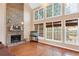 Gathering room with hardwood floors, stone fireplace, and wall of windows at 2265 Wildwood Lake Dr, Suwanee, GA 30024