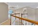 Upstairs hallway with railing overlooking the living room at 2265 Wildwood Lake Dr, Suwanee, GA 30024