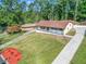 Aerial view of a renovated ranch house with a long driveway and landscaped yard at 2815 Spain Dr, East Point, GA 30344