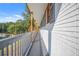 Long front porch with wooden posts and grey railings, overlooking a wooded area at 2815 Spain Dr, East Point, GA 30344