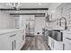 Modern kitchen with white cabinets, quartz countertops, and a farmhouse sink at 2815 Spain Dr, East Point, GA 30344