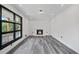 Modern living room with gray flooring, white brick fireplace and large windows at 2815 Spain Dr, East Point, GA 30344