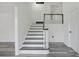 Modern staircase with dark gray steps and white risers at 2815 Spain Dr, East Point, GA 30344