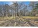 Large backyard with mature trees providing shade at 3422 Sweetbriar Ln, Powder Springs, GA 30127