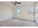 Bright bedroom with neutral carpet, ceiling fan and two windows at 3422 Sweetbriar Ln, Powder Springs, GA 30127