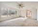 Sunlit living room with backyard access and ceiling fan at 3422 Sweetbriar Ln, Powder Springs, GA 30127