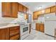 Kitchen with wood cabinets and white appliances at 64 Valley Hill Sw Rd, Riverdale, GA 30274