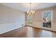 Formal dining room with hardwood floors and floral wallpaper at 1859 Olde Village Run, Dunwoody, GA 30338