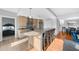 Modern kitchen with stainless steel appliances and an island with seating at 250 Park W Ave # 701, Atlanta, GA 30313